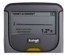 The Launch Pro display showing the Target Alignment screen after alignment is completed. The indicator light on the device changes color to confirm successful target alignment, while the screen displays the measured alignment offset of 1.2 degrees to the right and instructs the user to remove the alignment stick from view.
